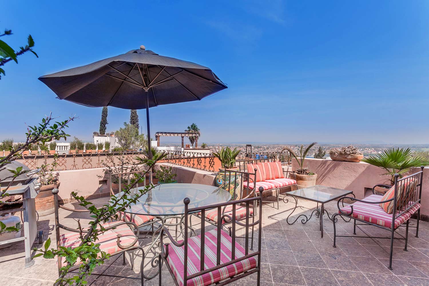 Photo of the Casa de la Vista View Terrace with Multiple Seating Areas and Umbrella and Table